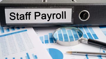 Staff Payroll. Binder data finance report business with graph analysis in office.